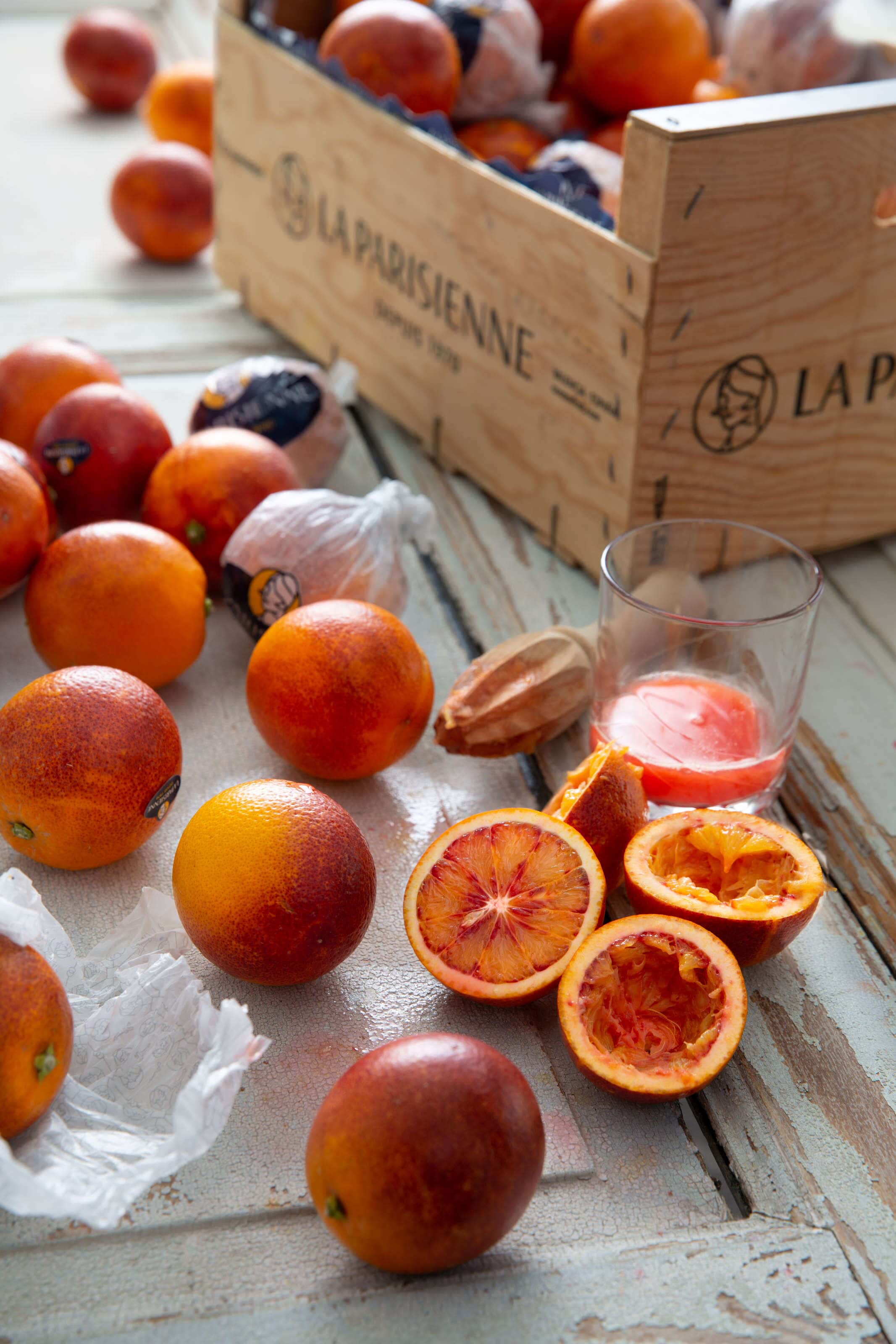 Blood oranges sliced opened and juiced and some in a box.