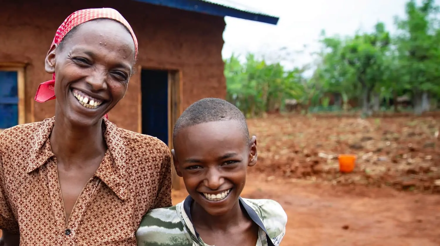 Workinesh Alto with her sons, Assamimow and Abinet, outside the new family home, built with profits from her agricultural trading business, which she set up in the wake of taking part in REGRADE, a graduation-based program run by Concern in SNNPR, Ethiopia.