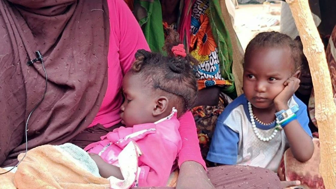 Nadia* holding her child Fiza* at Adré, a refugee camp in the east of Chad