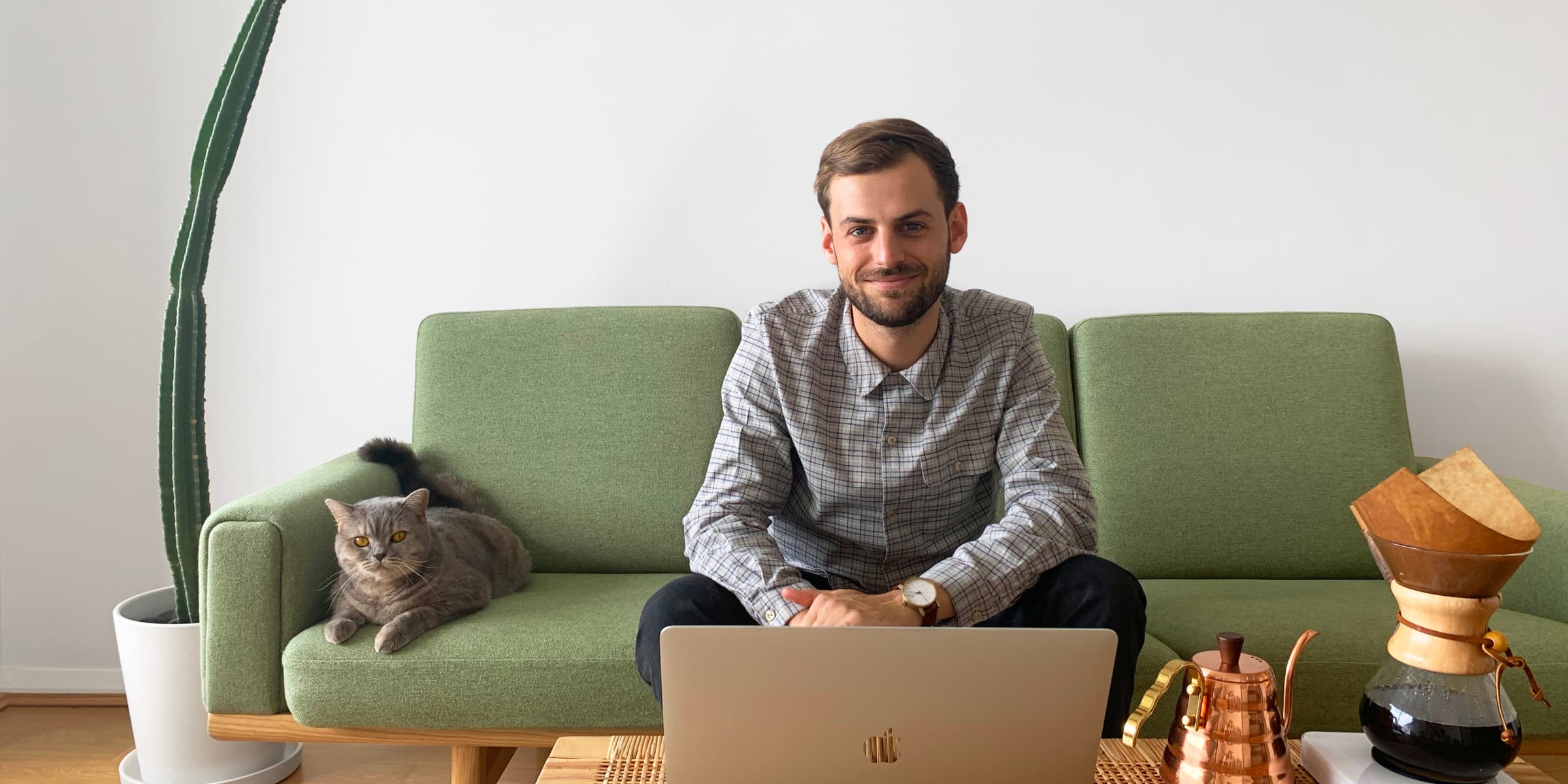 Product UX/UI Designer, Jordan Hughes, sitting on couch