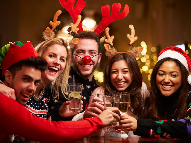 Five people celebrating the Christmas Day Drinking Game with a Social by clinking their drinks