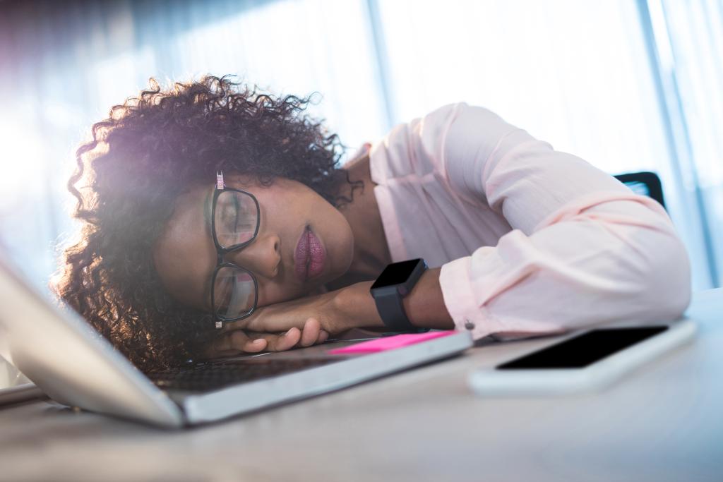 Woman asleep at a laptop