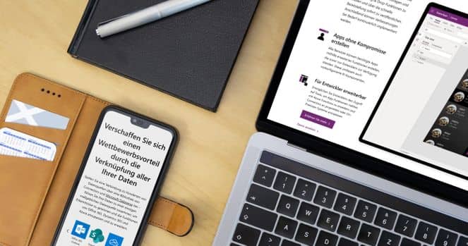Die App für die digitale Datenerfassung Ein Schreibtisch mit Handy, Laptop und Notizbuch
