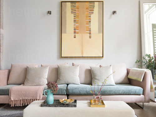 Large pink and blue pastel coloured sofa with white footrest in front of a large piece of modern art  Skype background