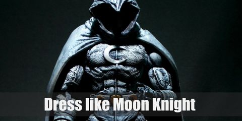 Moon Knight wears a black and white (mostly white) costume. He also loves his billowing hooded cape and full face mask.