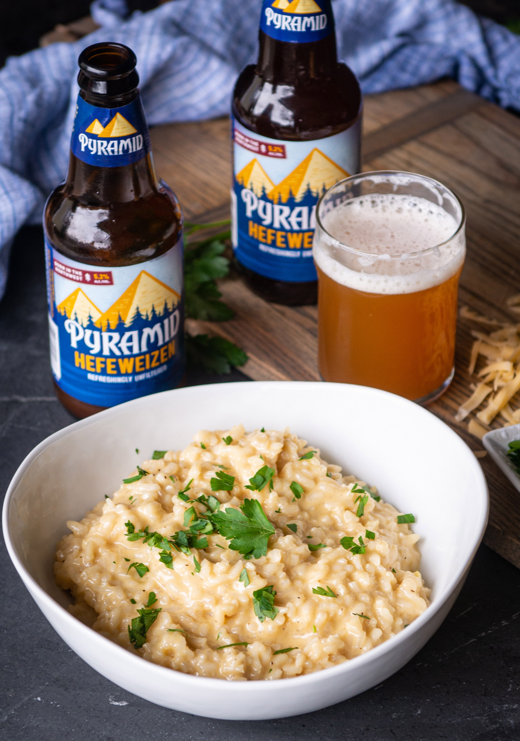 Bowl of Hearty Hefeweizen And Gouda Risotto with a bottle and glass of Pyramid Hefeweizen
