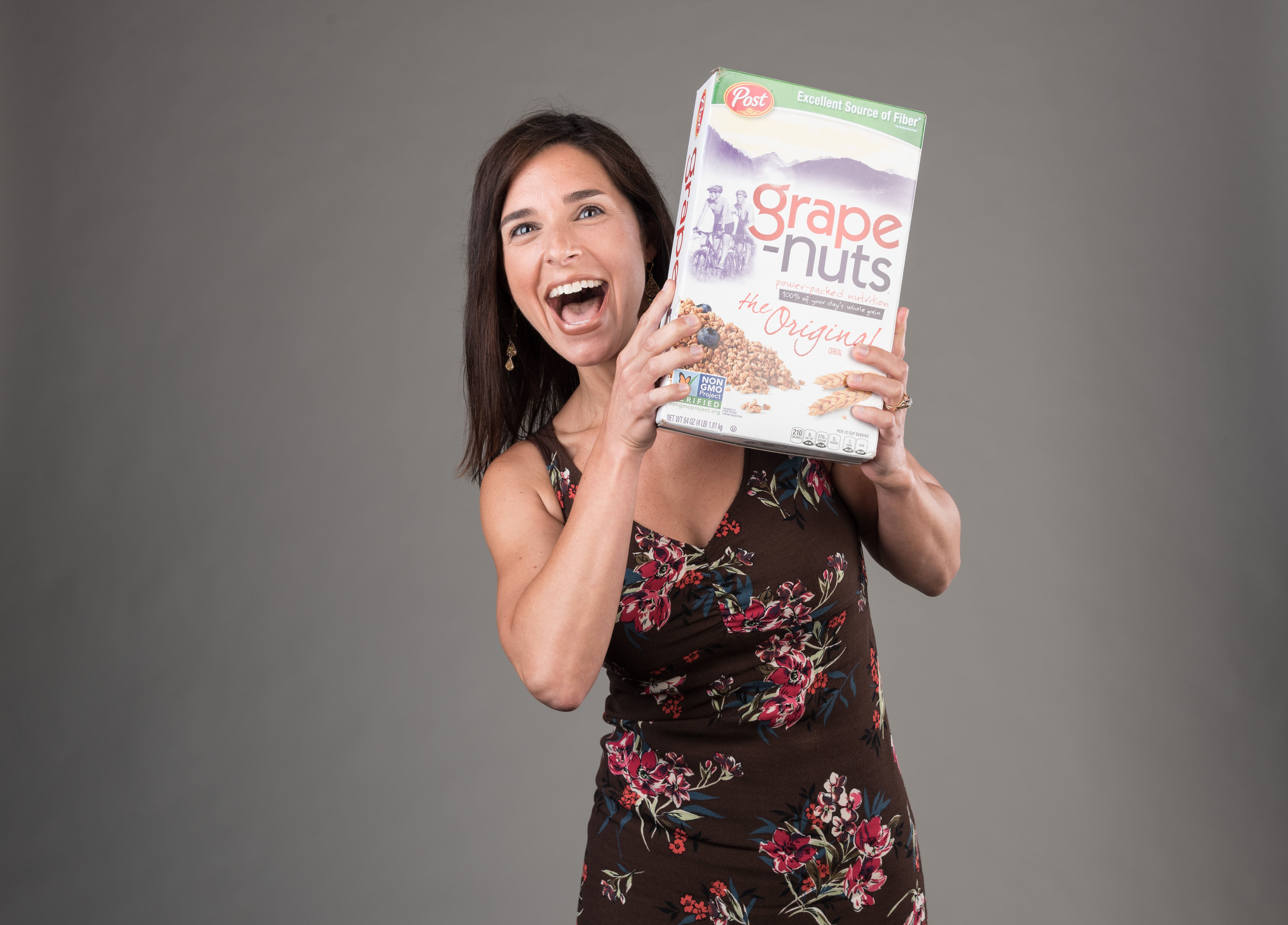Portrait of woman holding cereal box