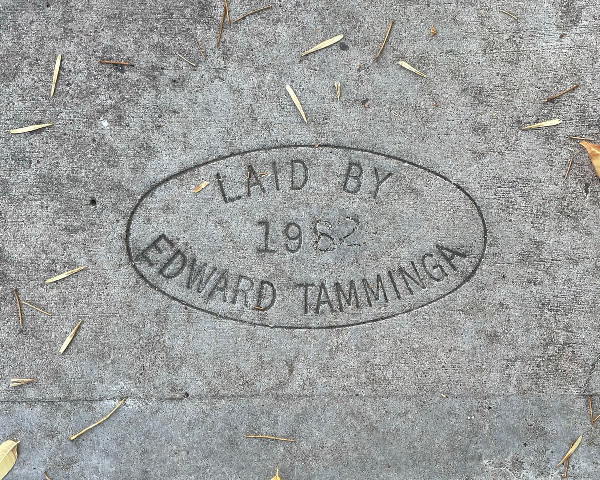 Seal imprinted in sidewalk. “Laid by Edward Tamminga.” 1982.
