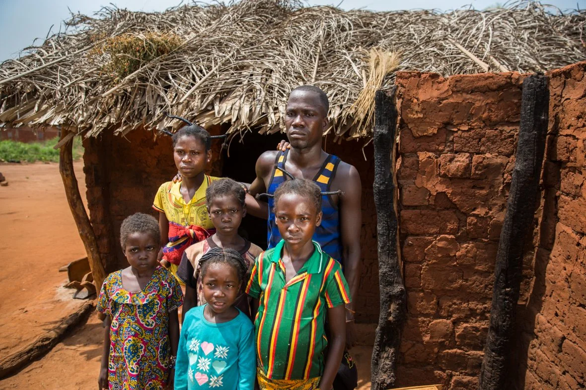 Lidi and her family outside their rebuilt home in in Kouango, Central African Republic.