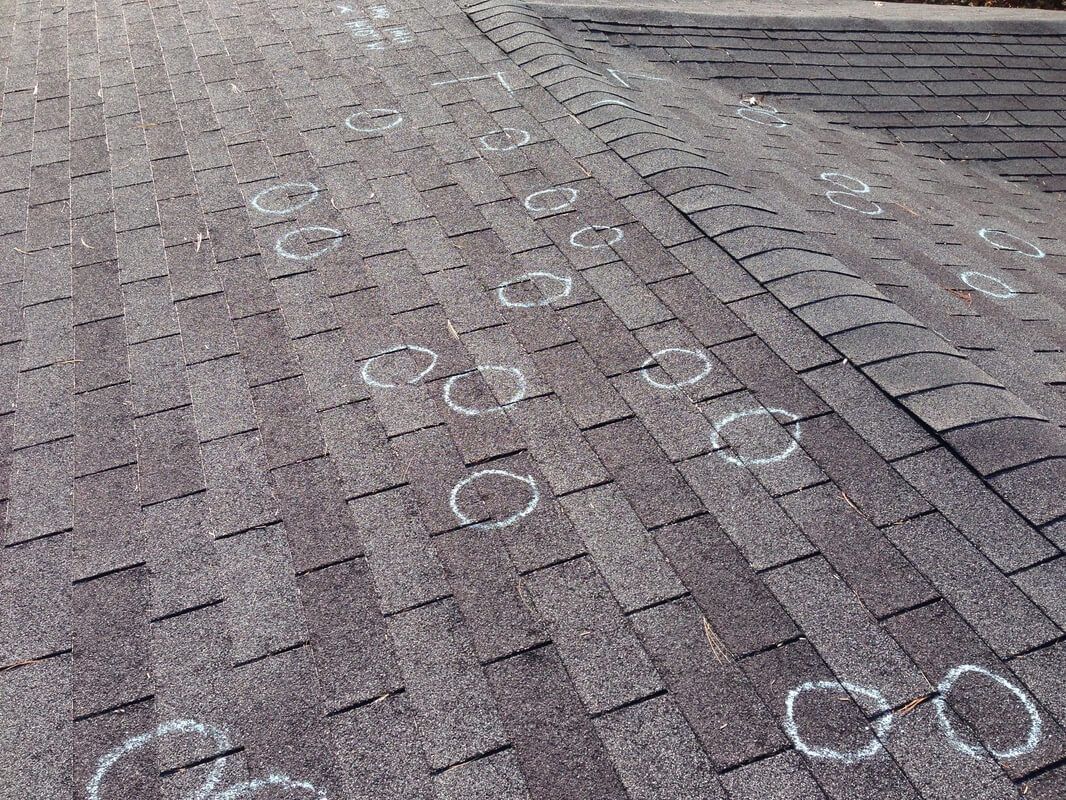 Chalk circles around hail damage spots on roof