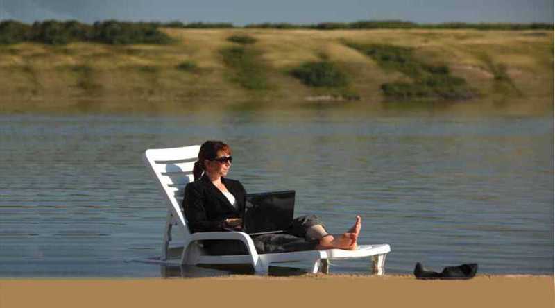 Woman on laptop at Manitou Beach