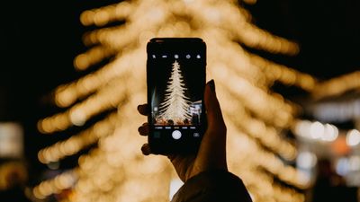 A phone camera photographing a Christmas tree