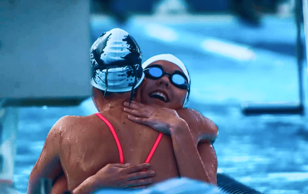 Swimmers hugging