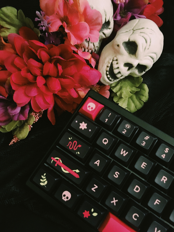 Gardenfall surrounded by flowers and skull props.