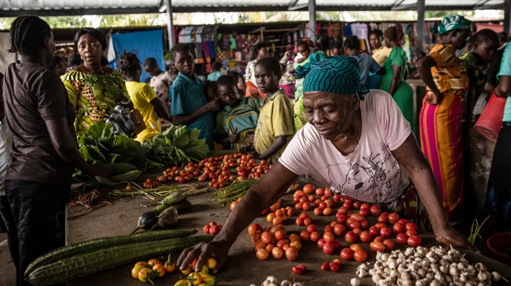 A Congolese woman sets up her vegetables at local market in Manono Territory, DRC