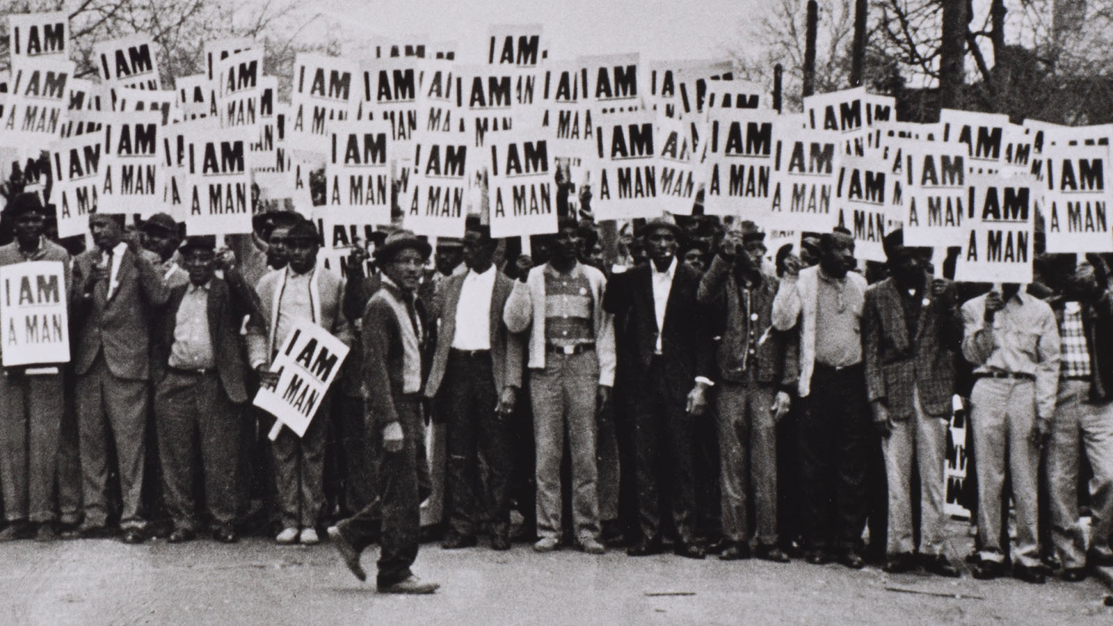 A black-and-white photo of a group of men holding picket signs that read 'I AM A MAN.'