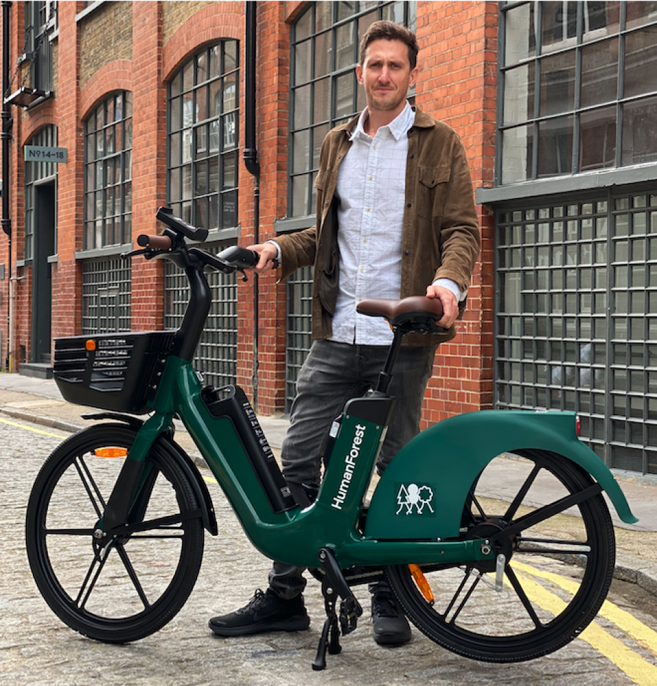 Agustin Guilisasti standing and holding the Human Forest e-bike in London.