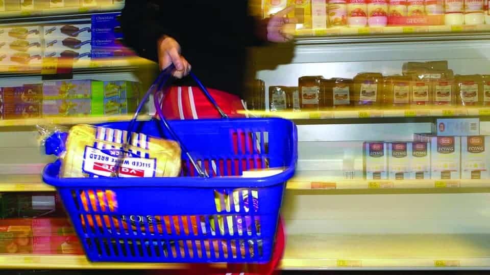 shopper with a basket of Tesco products