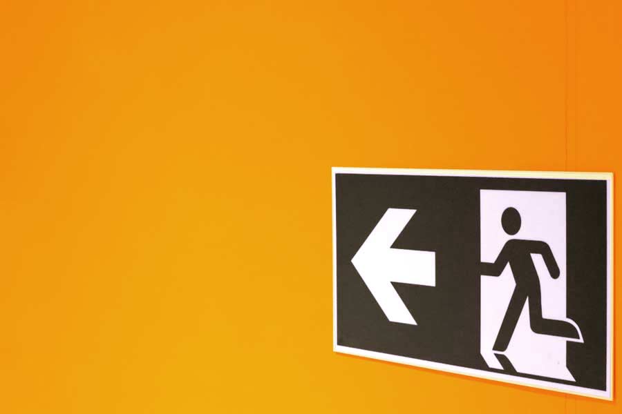 Exit sign on an orange wall