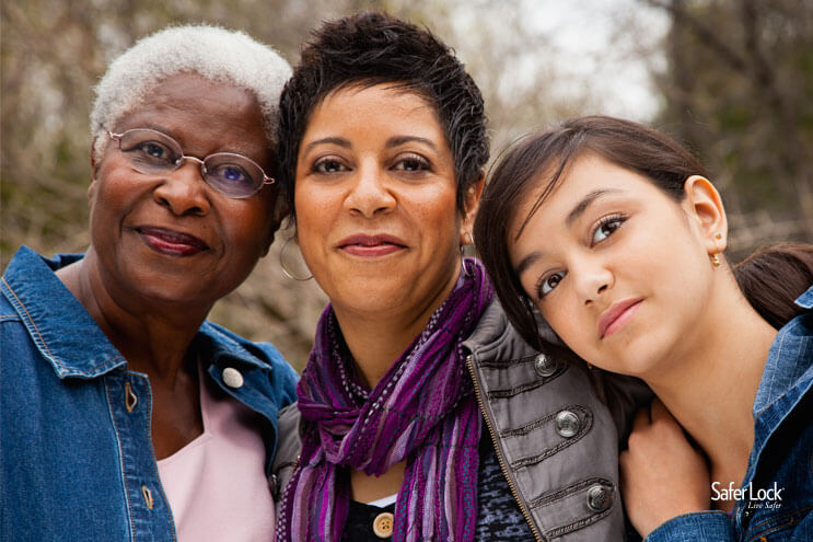 Three generations of women smiling at the camera.