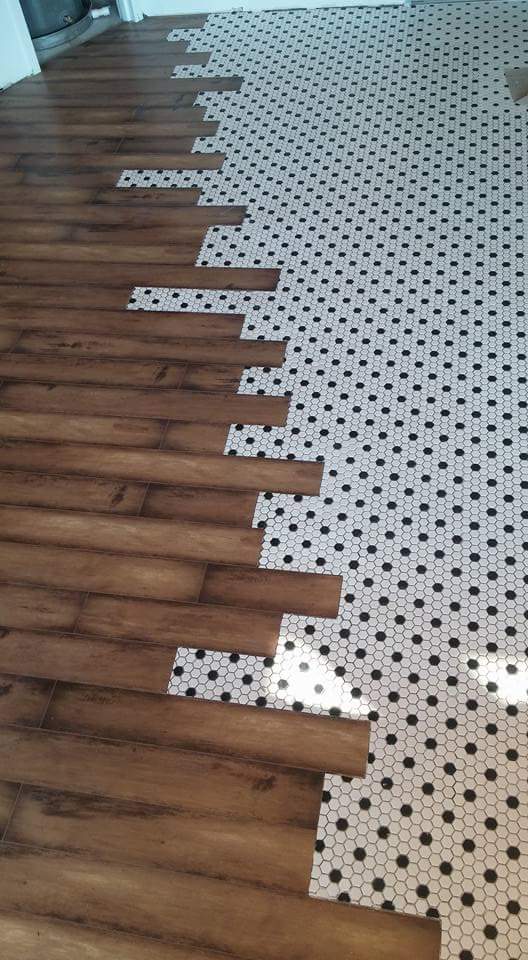 Custom tile with interlocking wood flooring by Dream Concepts Contracting LLC.