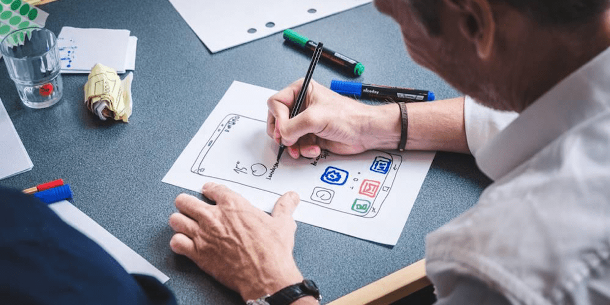 A UI designer creating a wireframe for a user interface A UI designer creating a wireframe for a user interface