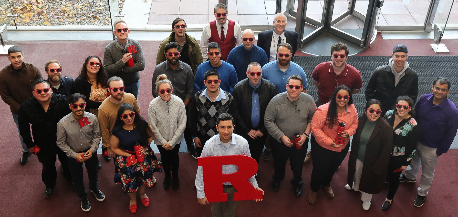 Rutgers boot camp students holding the letter R