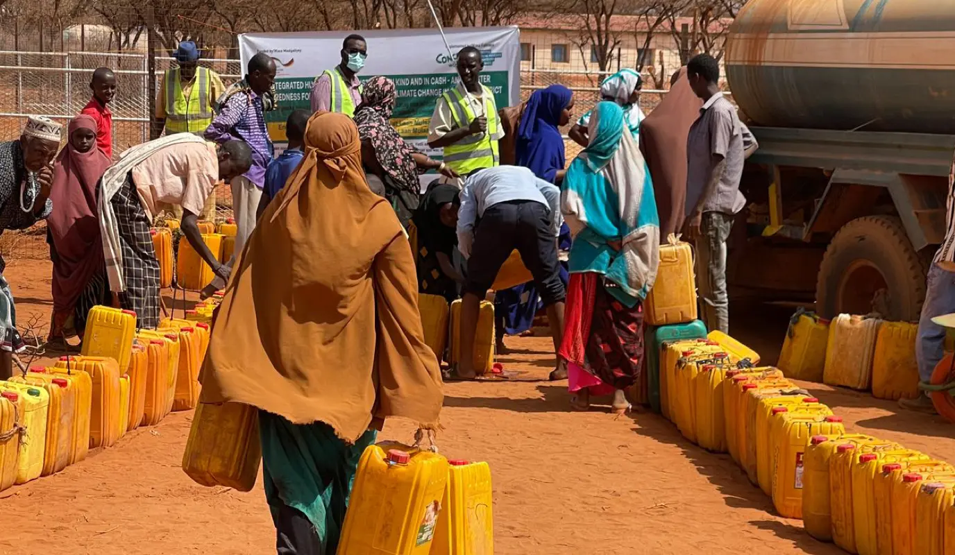 A Somali woman walks to Concern's water truck to fill up her containers for her family in Odweyne in the Toghdeer district where water sources have dried up due to drought.