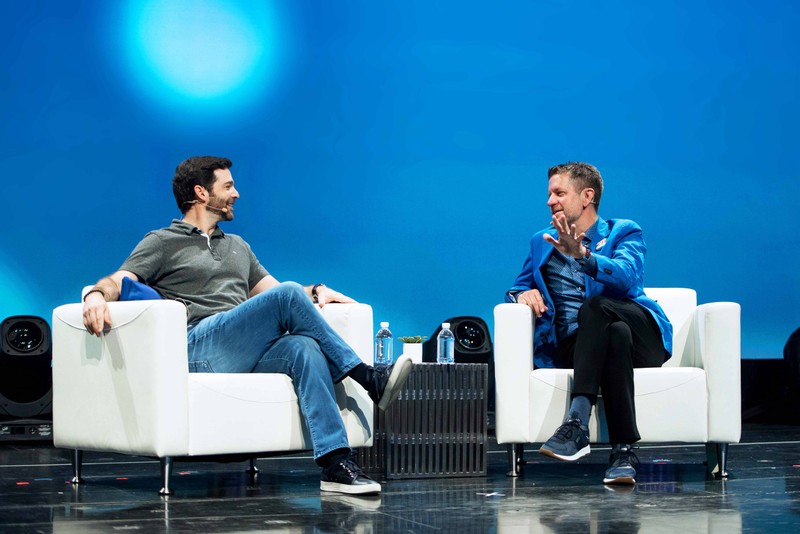 2U CEO and Co-Founder Chip Paucek speaks onstage sitting in white chairs
