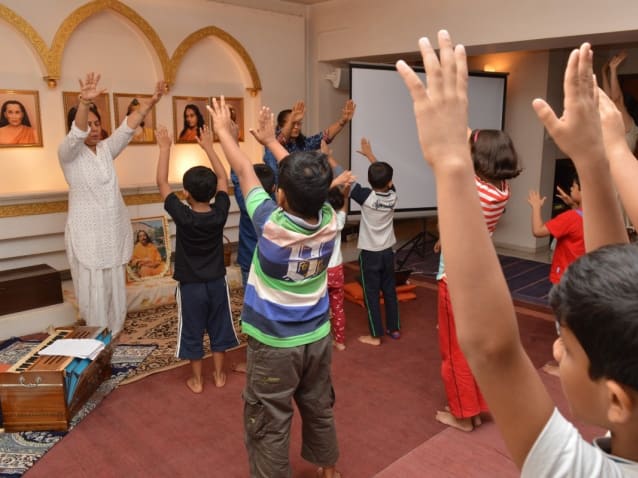 Children doing the healing technique of YSS