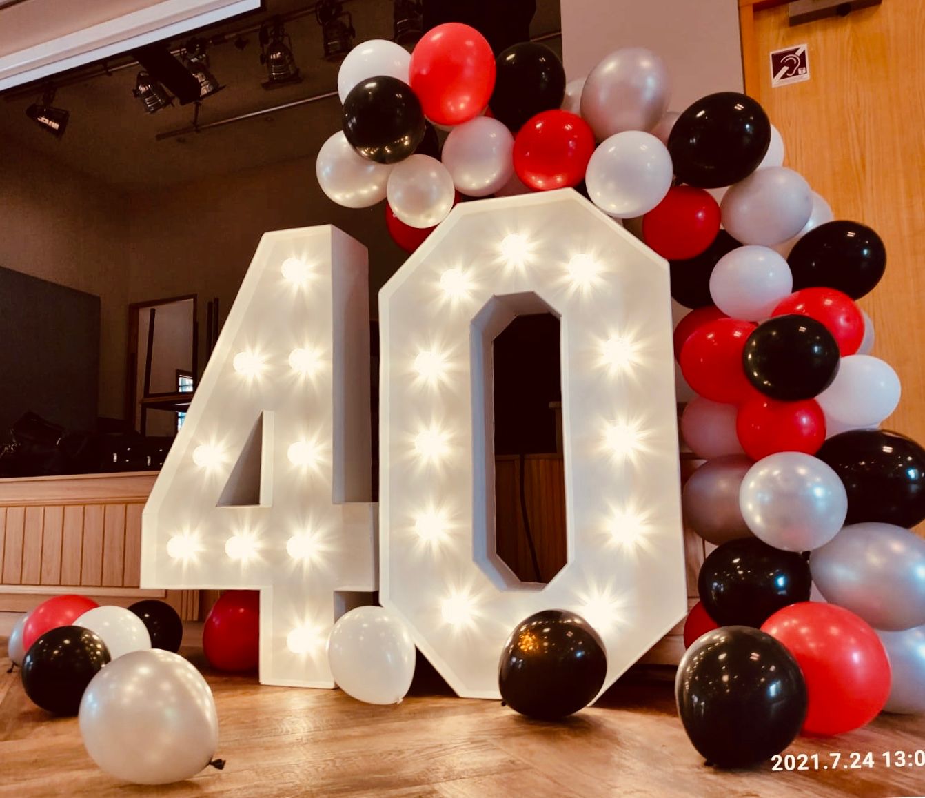 Big LED letters spelling out 40, surrounded by balloons