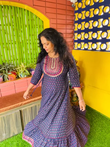 Photograph of Shweta in a traditional dress in a colorful room