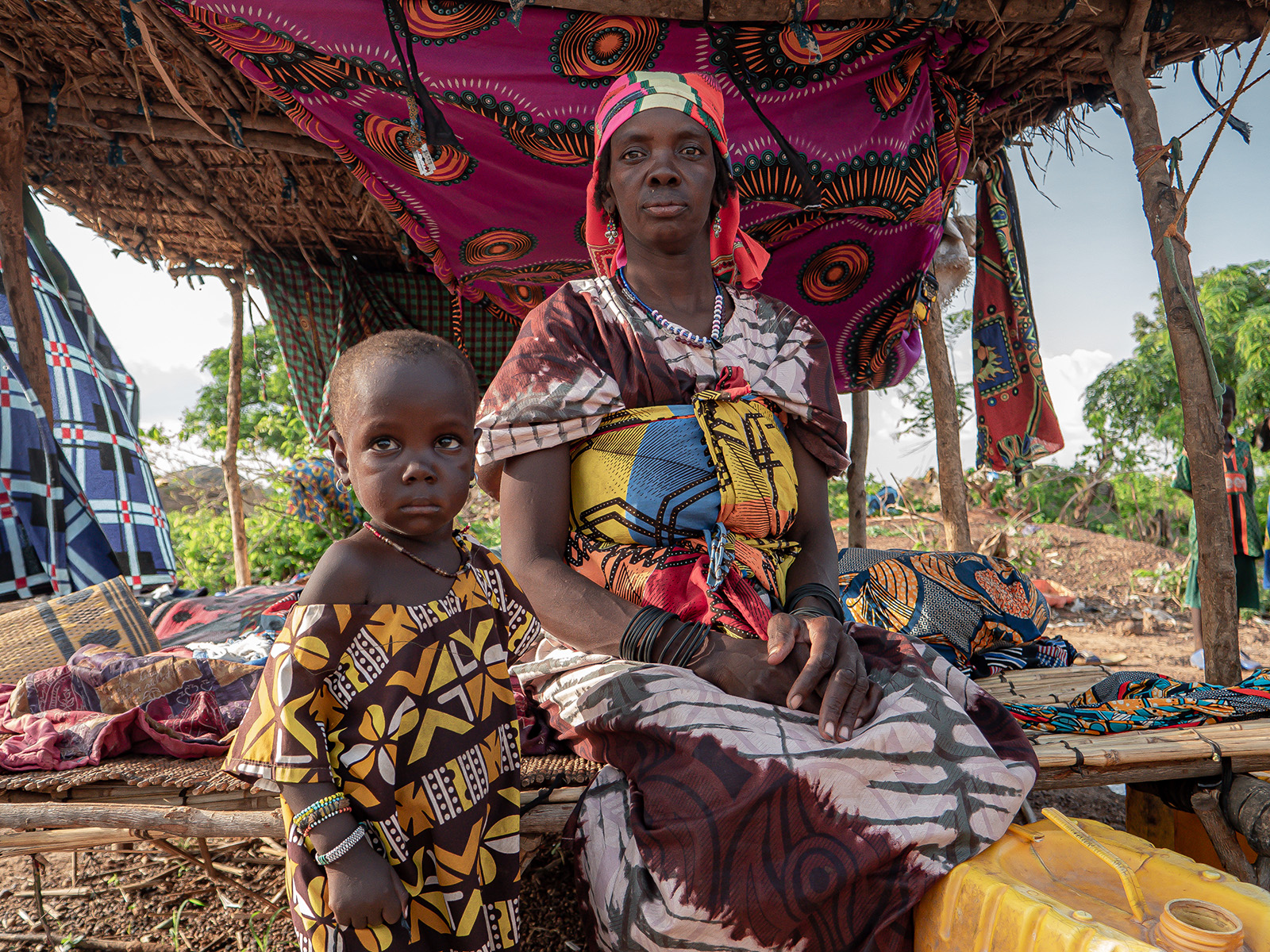Puebla* with her two children at an unofficial IDP site in the Centre North region of Burkina Faso where community leaders say food shortages are a constant worry with no state or NGO support.