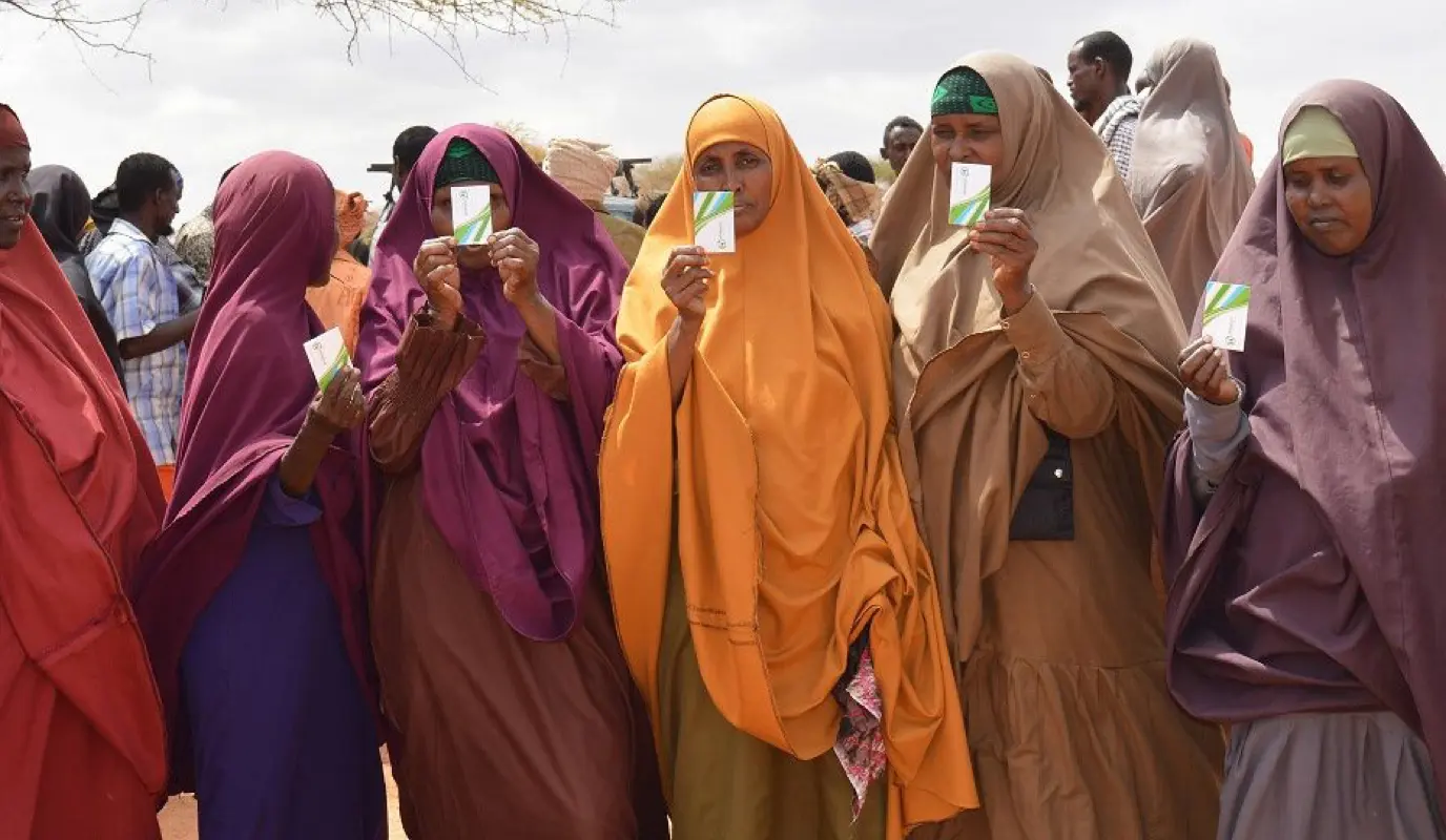 Somali women holing up SIM cards used for cash transfers.