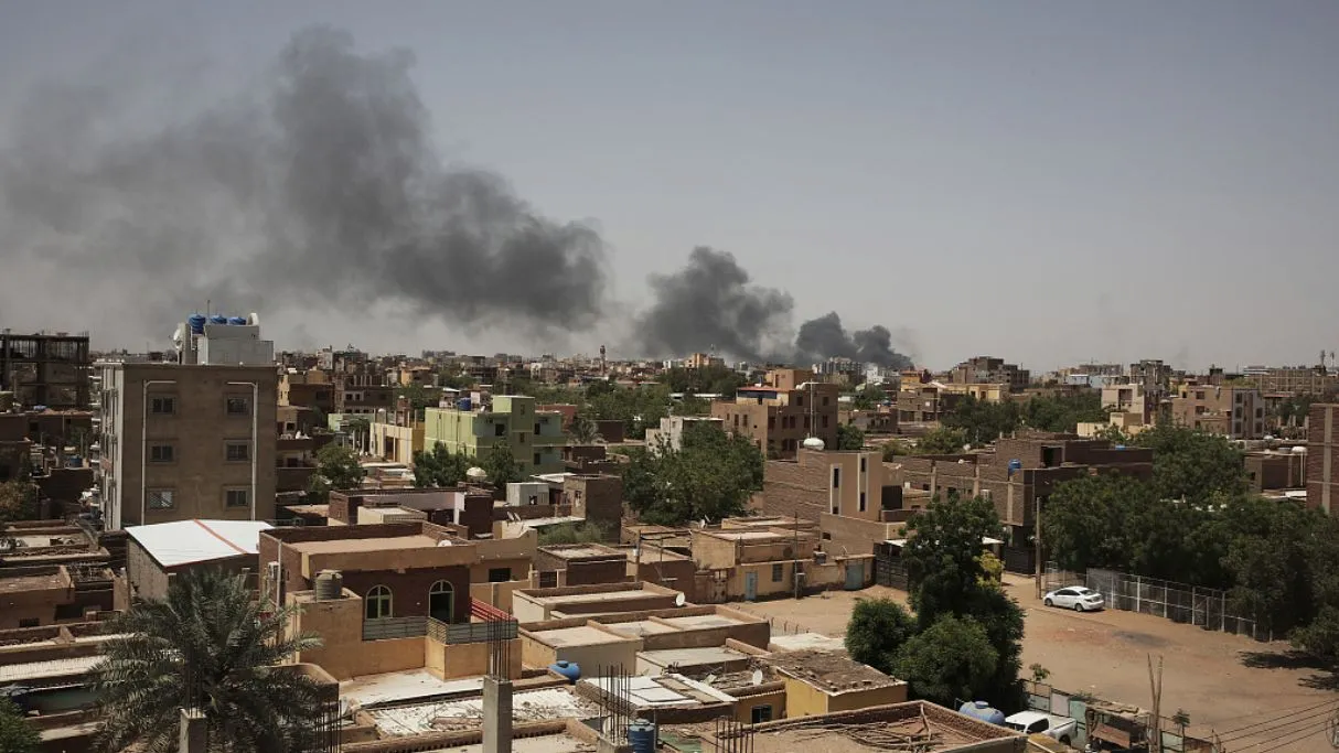 smoke rises over Khartoum