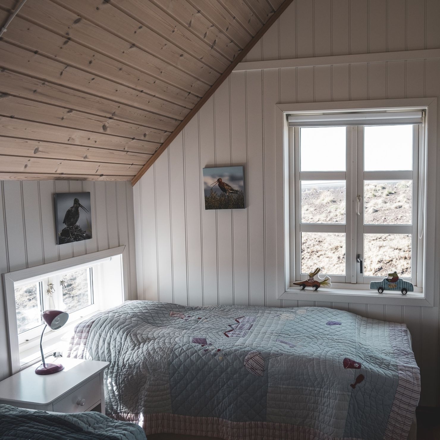 One bedroom in the converted attic with transom window