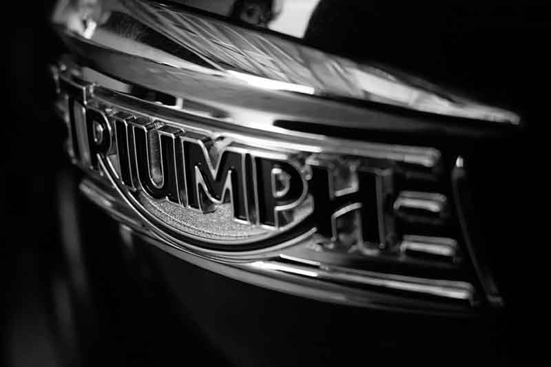 Closeup of a Triumph tank badge in black and white