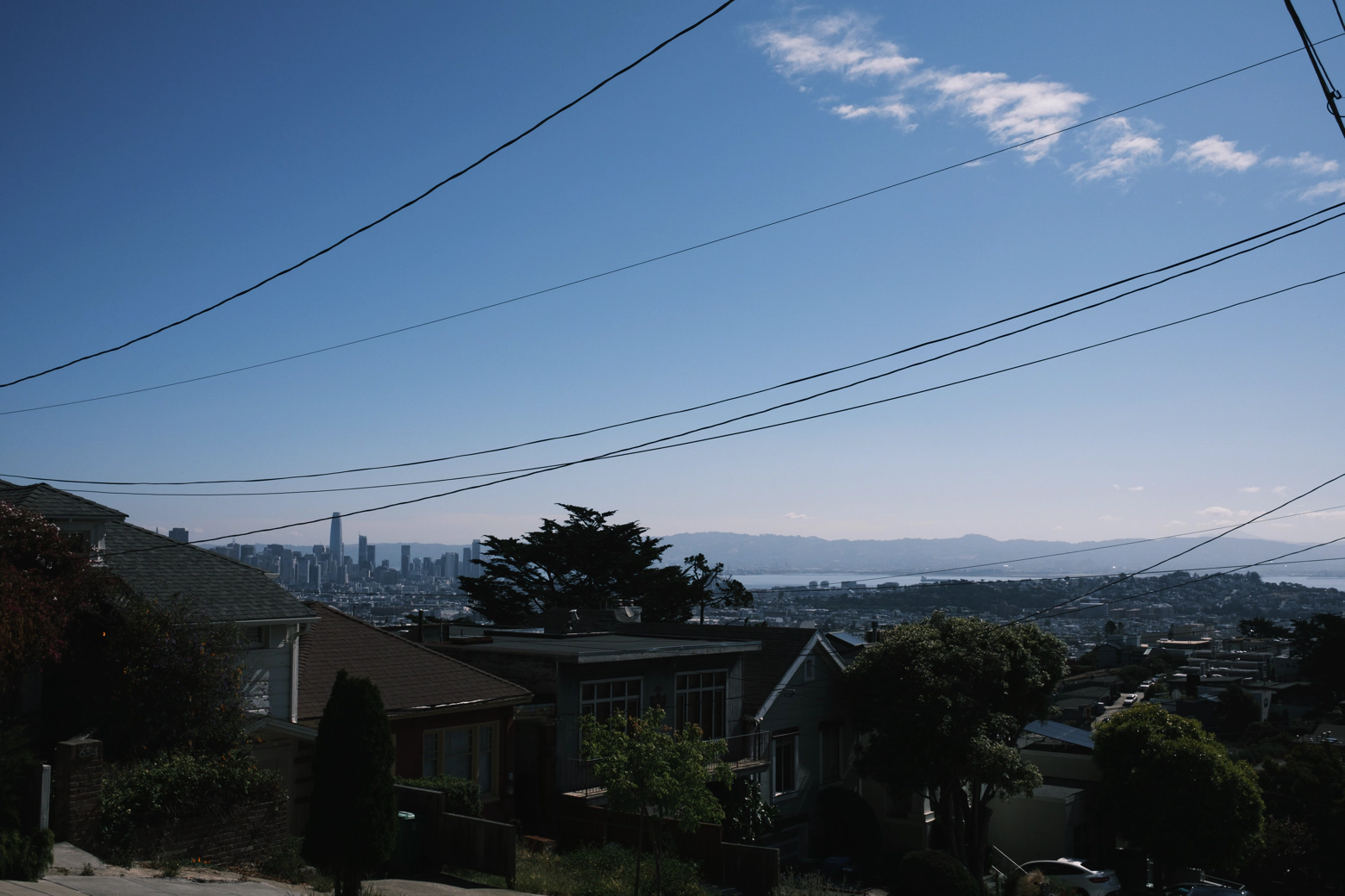 A lazy Sunday perfectly captured: criss-crossing electrical lines, a great blue sky, the hills of Noe Valley in San Francisco.