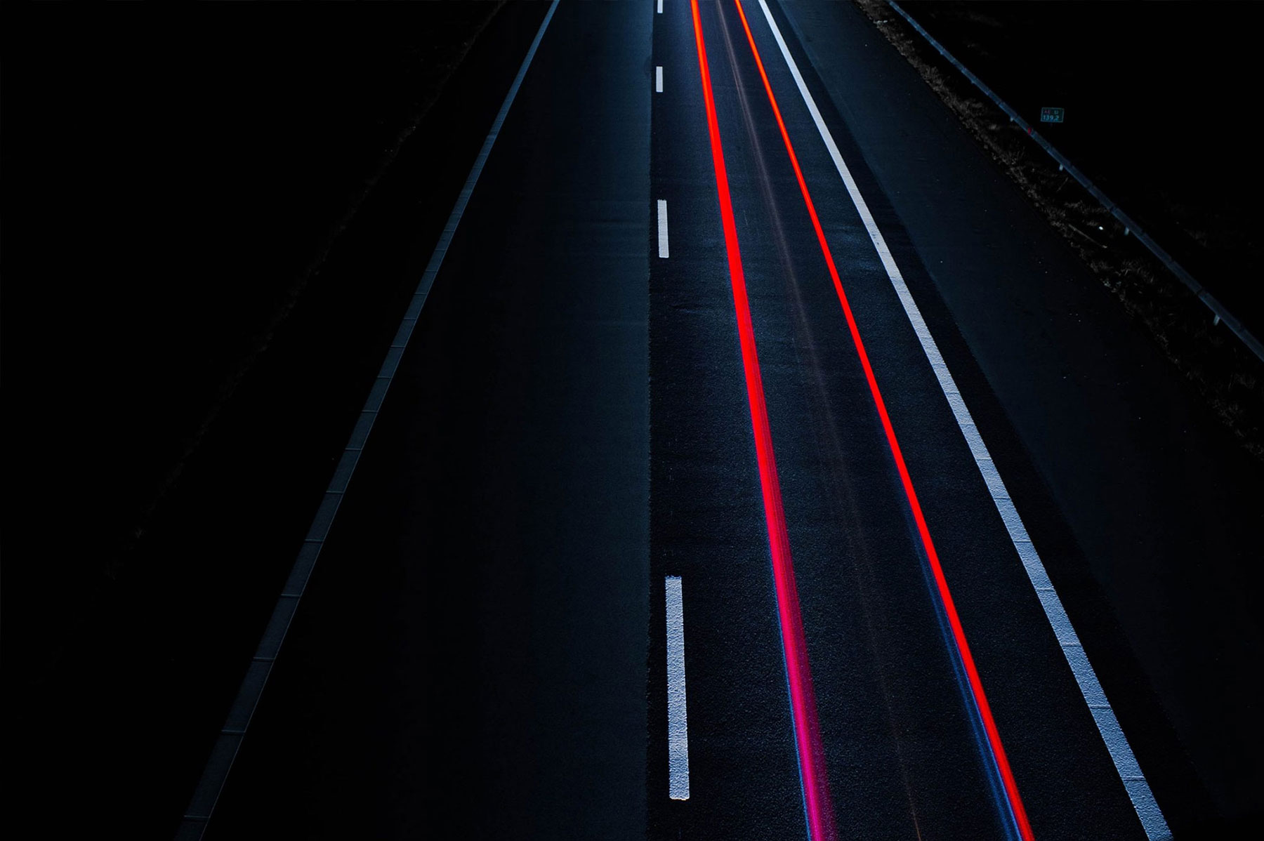 Long-exposure of brake lights on road