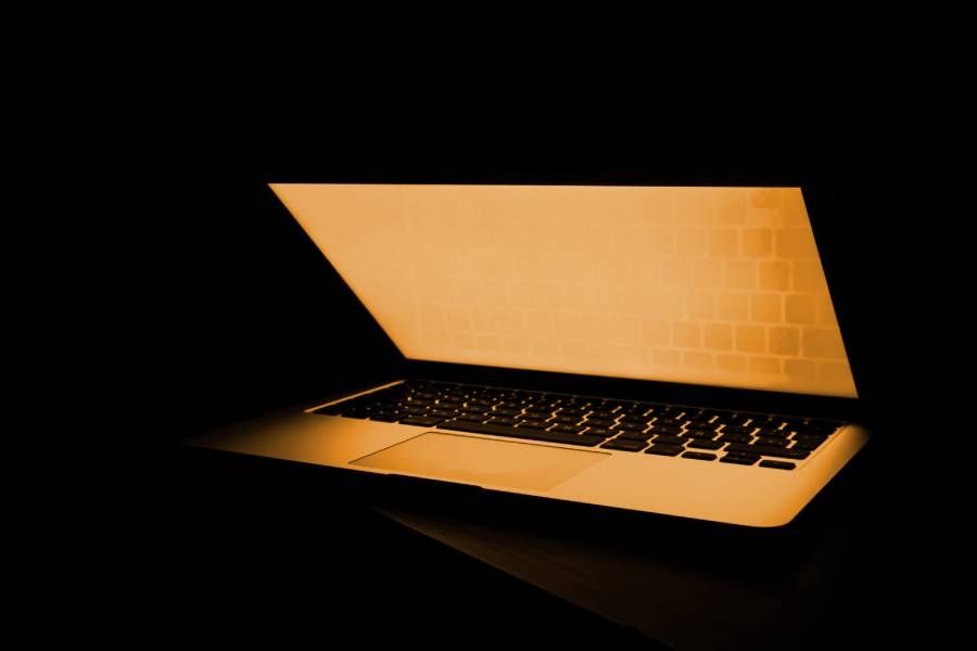 laptop with glowing orange screen