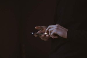 Person scrolling on a cell phone