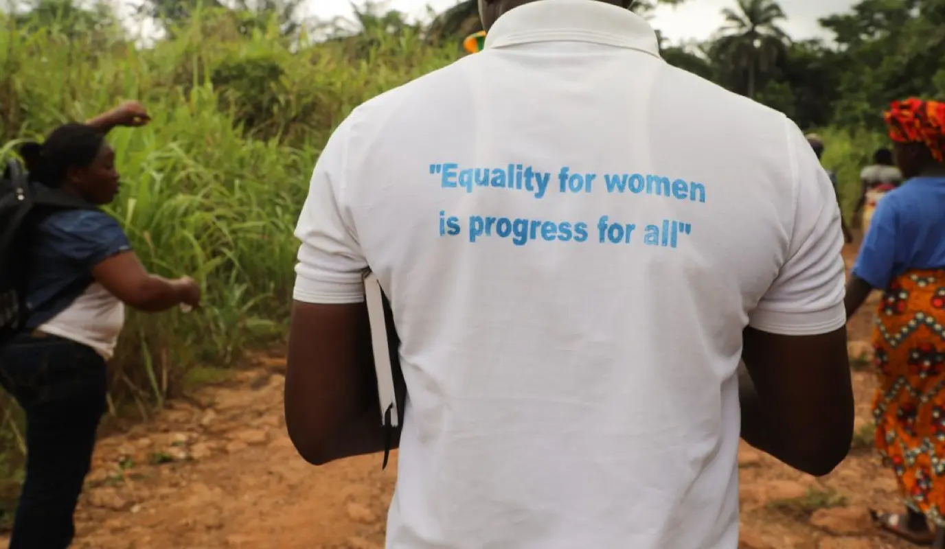 A man in Sierra Leone wears a gender quality t-shirt.