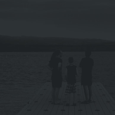 a family of three on a dock