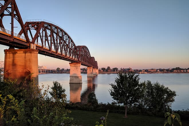A steel foot bridge over the Ohio River, seen just after dawn.
