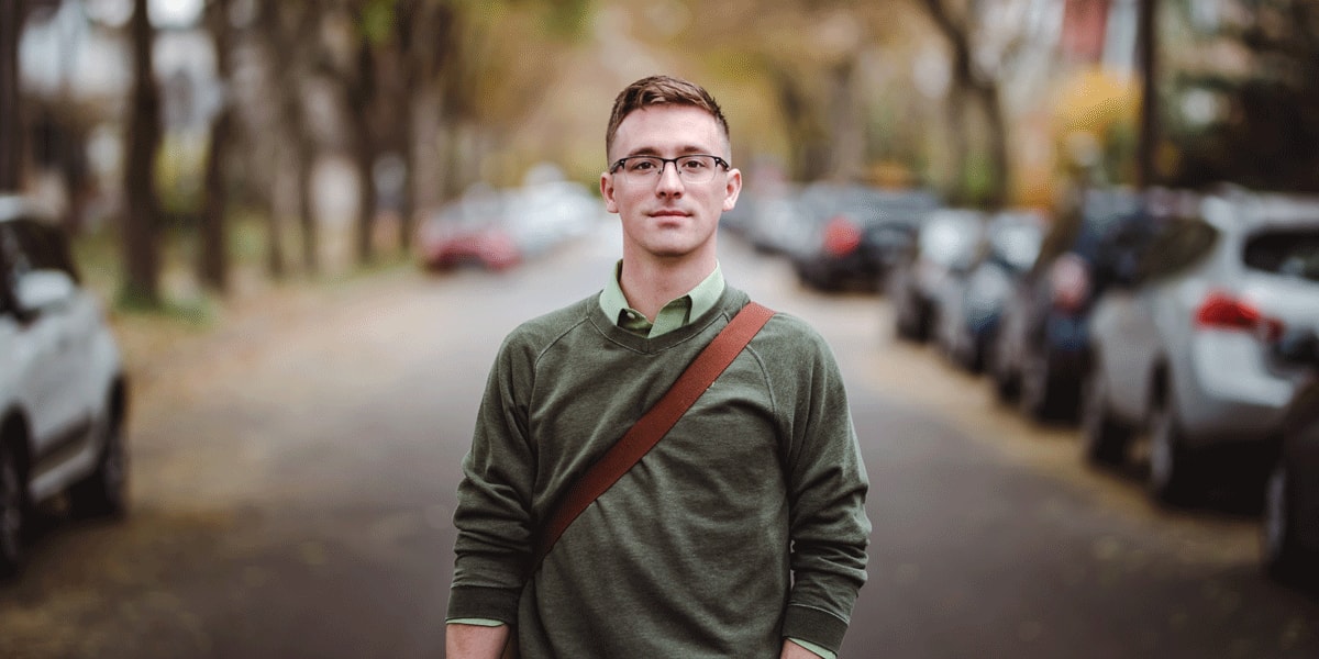 UX bootcamp student standing on a road and smiling UX bootcamp student standing on a road and smiling