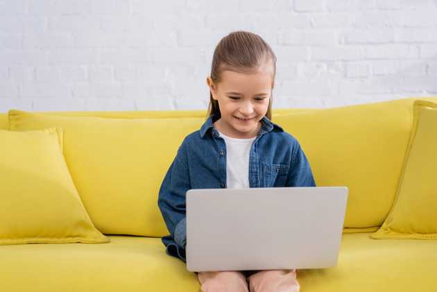 Young child studying on laptop