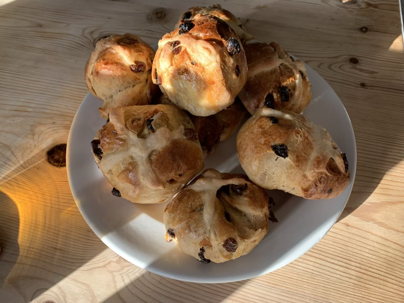 A plate with some freshly made sourdough hot cross buns on.