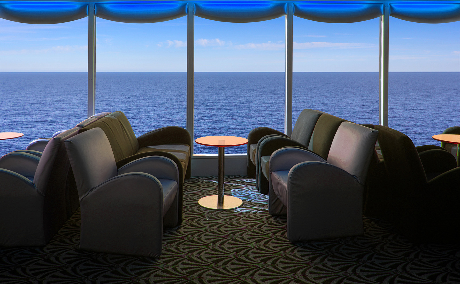 blue lounge chairs in a cruise ship salon