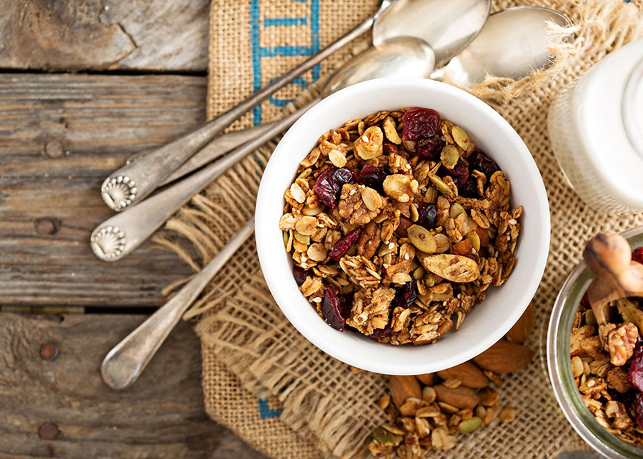 colorful granola in a bowl on a wooden table
