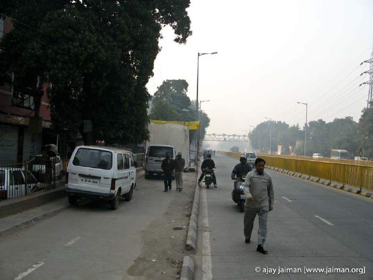 Pedestrians are being forced to walk on the road, cars are in the cycle lane, and of course the pandal is smack in the middle of everything